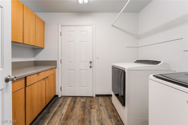 5217 Cold River Ave, Las Vegas, NV 89130 - laundry area with cabinet space, washer and clothes dryer, and dark wood finished floors