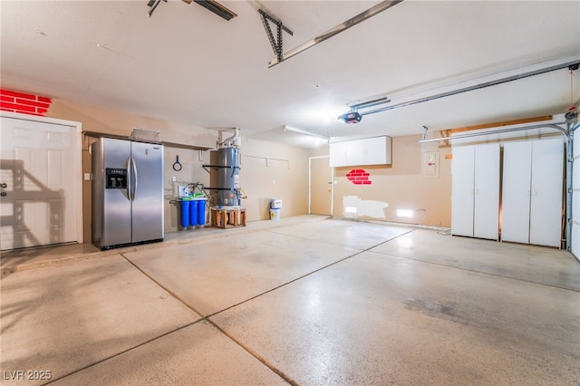 5217 Cold River Ave, Las Vegas, NV 89130 - garage featuring stainless steel fridge and a garage door opener