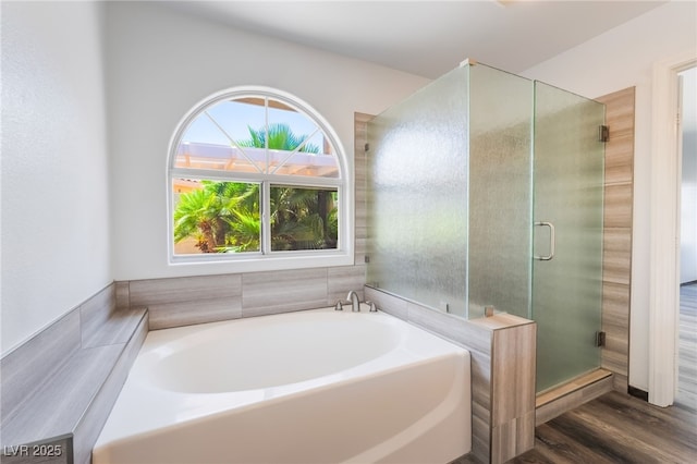 5217 Cold River Ave, Las Vegas, NV 89130 - full bathroom with a bath, a stall shower, and wood finished floors