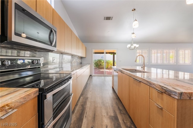 5217 Cold River Ave, Las Vegas, NV 89130 - kitchen with stainless steel appliances, dark wood finished floors, backsplash, a kitchen island with sink, and a chandelier