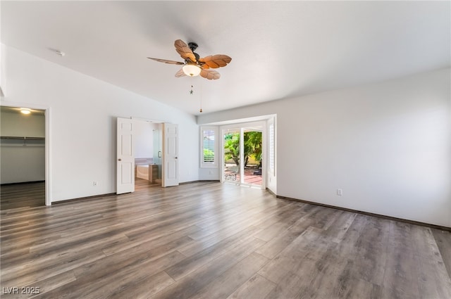 5217 Cold River Ave, Las Vegas, NV 89130 - unfurnished bedroom with wood finished floors, access to exterior, lofted ceiling, a walk in closet, and a ceiling fan
