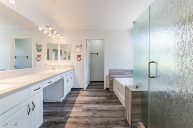 5217 Cold River Ave, Las Vegas, NV 89130 - bathroom with double vanity, a bath, wood finished floors, and a shower stall