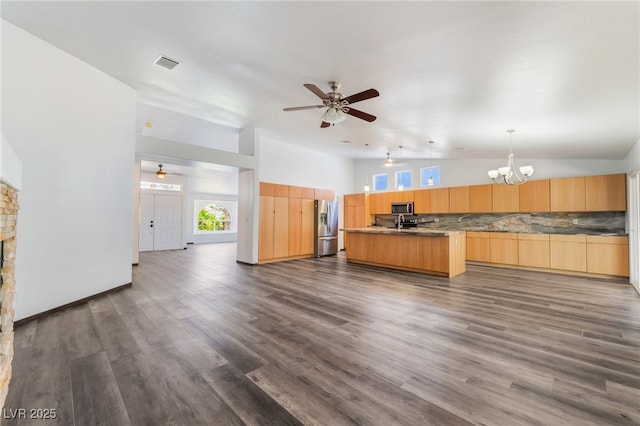 5217 Cold River Ave, Las Vegas, NV 89130 - unfurnished living room featuring a ceiling fan, vaulted ceiling, a chandelier, dark wood-style flooring, and a fireplace