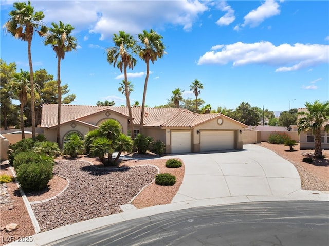 5217 Cold River Ave, Las Vegas, NV 89130 - mediterranean / spanish-style home with stucco siding, an attached garage, driveway, and a tile roof