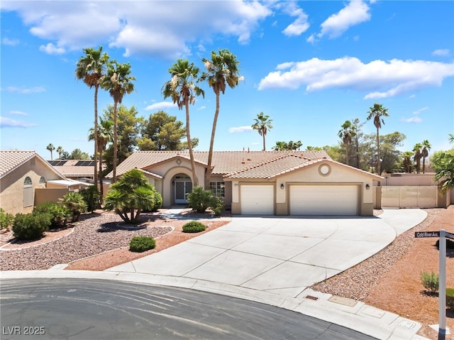 5217 Cold River Ave, Las Vegas, NV 89130 - mediterranean / spanish house featuring an attached garage, concrete driveway, stucco siding, and a tiled roof