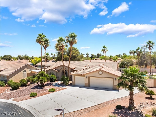 5217 Cold River Ave, Las Vegas, NV 89130 - mediterranean / spanish house featuring stucco siding, a tiled roof, an attached garage, and concrete driveway