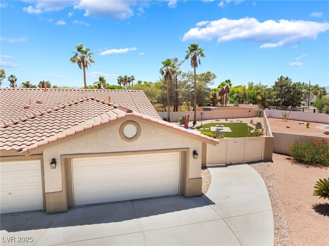 5217 Cold River Ave, Las Vegas, NV 89130 - view of front facade with stucco siding, a tiled roof, a garage, and concrete driveway