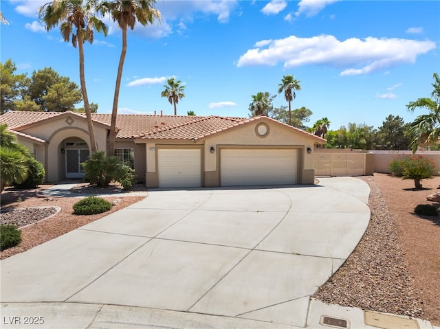 5217 Cold River Ave, Las Vegas, NV 89130 - mediterranean / spanish-style home with a garage, stucco siding, driveway, and a tile roof