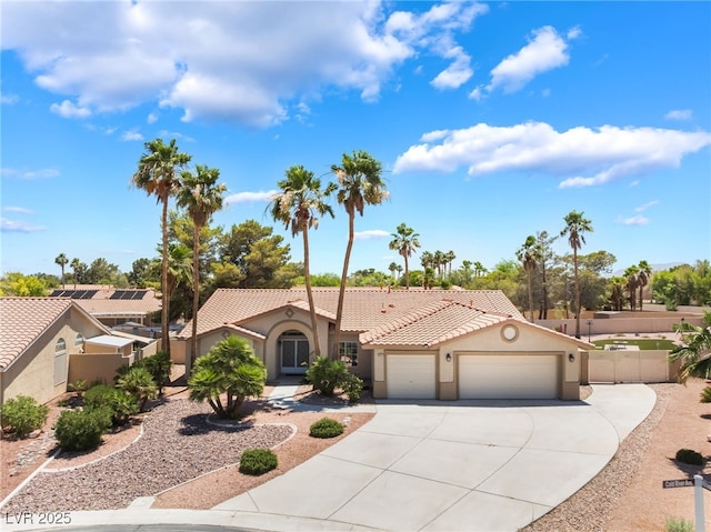 5217 Cold River Ave, Las Vegas, NV 89130 - mediterranean / spanish-style house with stucco siding, an attached garage, driveway, and a tile roof