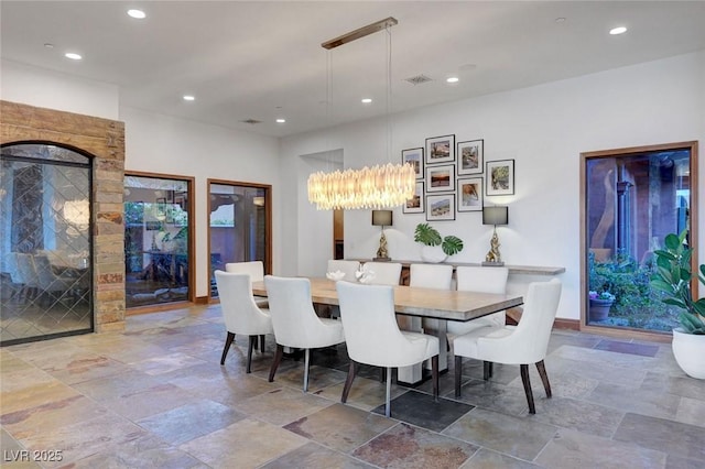 15 Rue Du Rivoli Pl, Henderson, NV 89011 - dining room featuring stone tile flooring, a chandelier, and recessed lighting