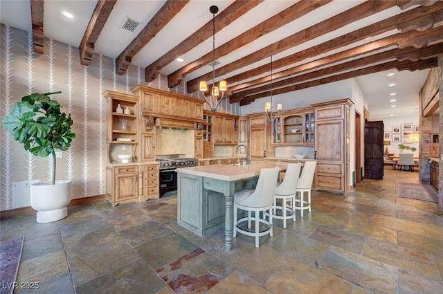 15 Rue Du Rivoli Pl, Henderson, NV 89011 - kitchen with high end stainless steel range oven, open shelves, stone tile flooring, light countertops, and wallpapered walls