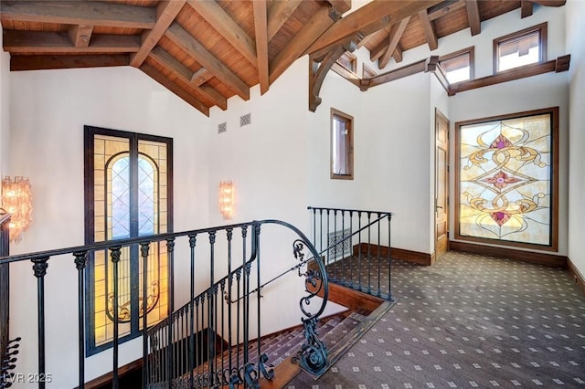 15 Rue Du Rivoli Pl, Henderson, NV 89011 - stairway with carpet flooring, a wooden ceiling with exposed beams, high vaulted ceiling, and a chandelier