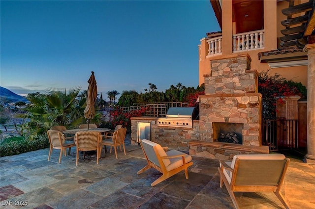 15 Rue Du Rivoli Pl, Henderson, NV 89011 - view of patio / terrace with an outdoor stone fireplace, outdoor dining space, and area for grilling