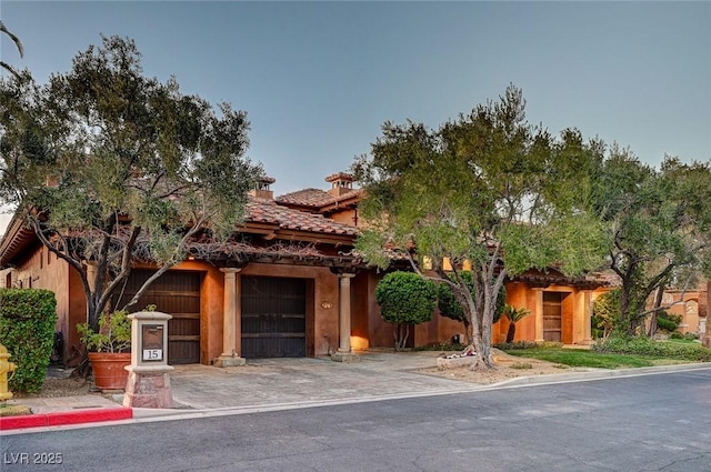 15 Rue Du Rivoli Pl, Henderson, NV 89011 - view of front of house featuring driveway, a tiled roof, and an attached garage