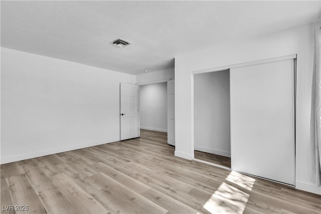 2204 Monterey Ave, Las Vegas, NV 89104 - unfurnished bedroom featuring wood finished floors, a closet, and baseboards