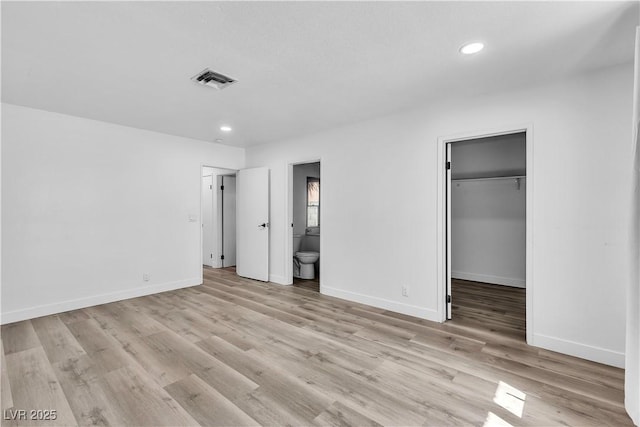 2204 Monterey Ave, Las Vegas, NV 89104 - unfurnished bedroom featuring recessed lighting, a spacious closet, baseboards, light wood-style flooring, and connected bathroom