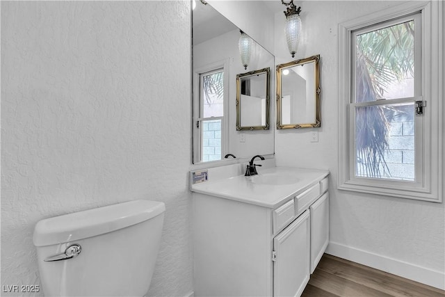 2204 Monterey Ave, Las Vegas, NV 89104 - bathroom featuring healthy amount of natural light, wood finished floors, toilet, and a textured wall