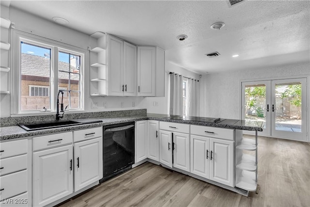 2204 Monterey Ave, Las Vegas, NV 89104 - kitchen with black appliances, open shelves, a peninsula, a sink, and light wood-style flooring
