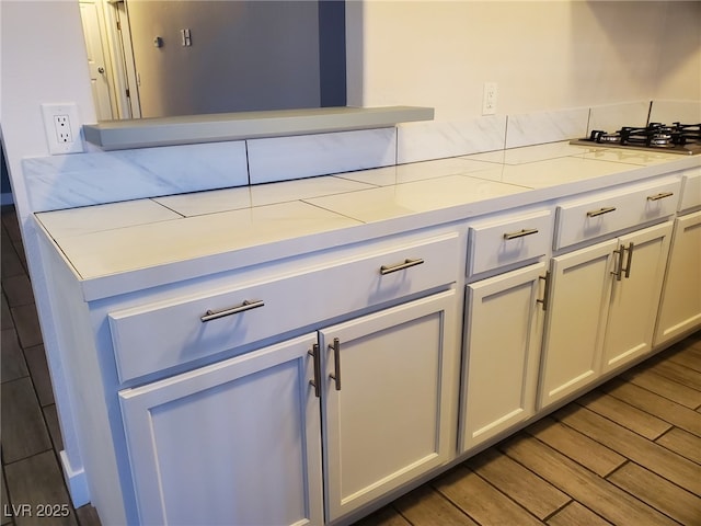 3168 S Eastern Ave Unit 45, Las Vegas, NV 89169 - kitchen featuring wood finished floors, light countertops, and stainless steel gas stovetop