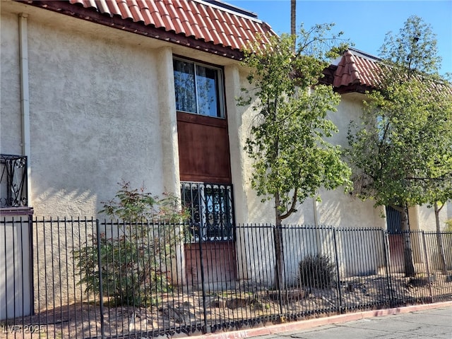 3168 S Eastern Ave Unit 45, Las Vegas, NV 89169 - view of property exterior with stucco siding and a tiled roof
