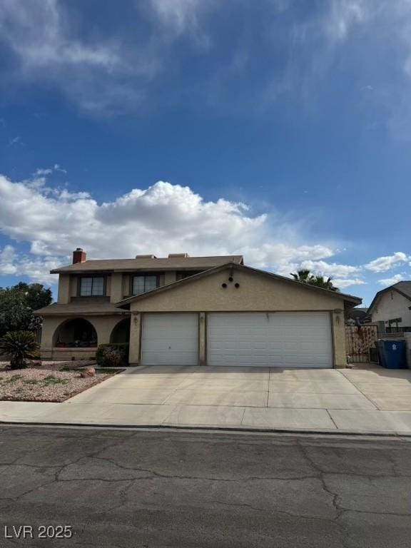 6801 Atwood Ave, Las Vegas, NV 89108 - view of front of property with fence, stucco siding, a garage, and concrete driveway