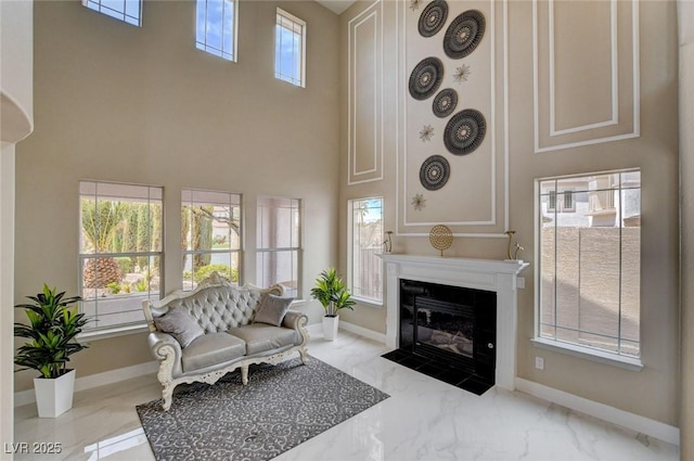 10550 Patrington Ct, Las Vegas, NV 89183 - living area featuring baseboards, a high ceiling, and marble finish floor