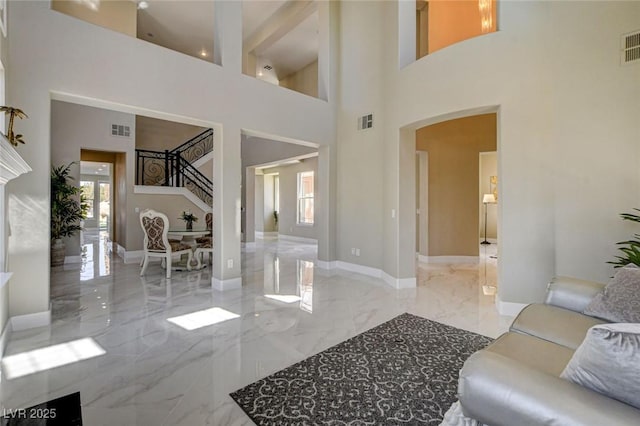 10550 Patrington Ct, Las Vegas, NV 89183 - living room featuring visible vents, marble finish floor, and a high ceiling