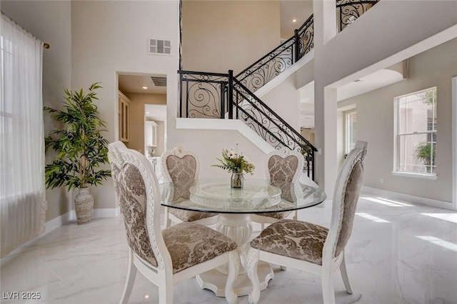 10550 Patrington Ct, Las Vegas, NV 89183 - dining room with visible vents, baseboards, a high ceiling, marble finish floor, and stairway