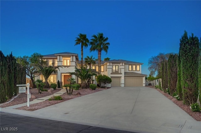 10550 Patrington Ct, Las Vegas, NV 89183 - mediterranean / spanish-style house featuring an attached garage, stucco siding, a balcony, and concrete driveway