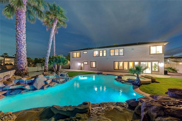 10550 Patrington Ct, Las Vegas, NV 89183 - pool at twilight with fence private yard, a pool with connected hot tub, and a patio