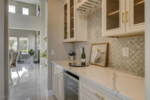 10550 Patrington Ct, Las Vegas, NV 89183 - bar featuring a healthy amount of sunlight, beverage cooler, and a bar