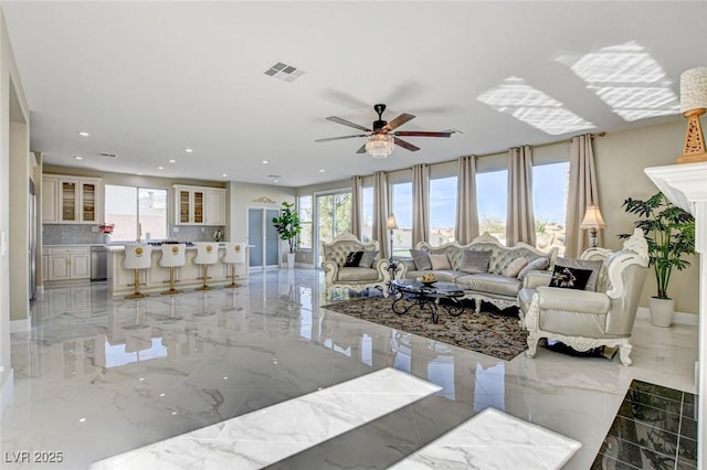 10550 Patrington Ct, Las Vegas, NV 89183 - living room featuring marble finish floor, a healthy amount of sunlight, and visible vents