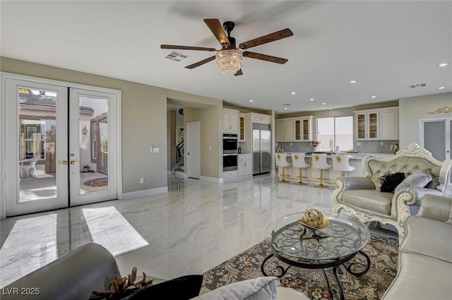 10550 Patrington Ct, Las Vegas, NV 89183 - living area featuring ceiling fan, french doors, marble finish floor, and visible vents