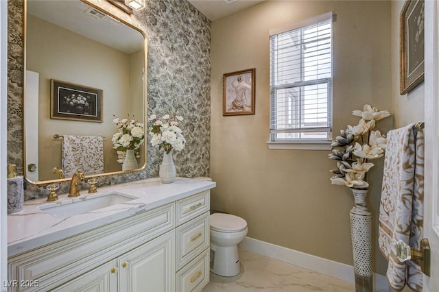 10550 Patrington Ct, Las Vegas, NV 89183 - bathroom with marble finish floor, visible vents, toilet, vanity, and baseboards