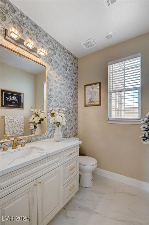 10550 Patrington Ct, Las Vegas, NV 89183 - bathroom with toilet, baseboards, visible vents, marble finish floor, and vanity