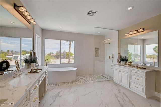 10550 Patrington Ct, Las Vegas, NV 89183 - bathroom featuring a freestanding bath, vanity, visible vents, and plenty of natural light