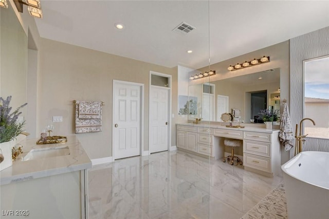 10550 Patrington Ct, Las Vegas, NV 89183 - bathroom with vanity, marble finish floor, a soaking tub, baseboards, and visible vents