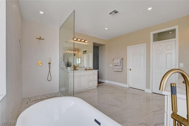 10550 Patrington Ct, Las Vegas, NV 89183 - full bath with a freestanding tub, marble finish floor, recessed lighting, and vanity
