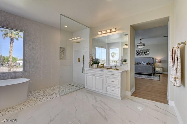 10550 Patrington Ct, Las Vegas, NV 89183 - full bathroom featuring a freestanding tub, baseboards, a healthy amount of sunlight, and a walk in shower