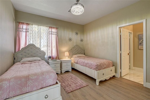 10550 Patrington Ct, Las Vegas, NV 89183 - bedroom with baseboards, a chandelier, and wood finished floors
