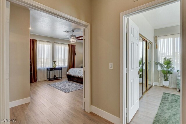 10550 Patrington Ct, Las Vegas, NV 89183 - hall with baseboards, wood finished floors, and visible vents