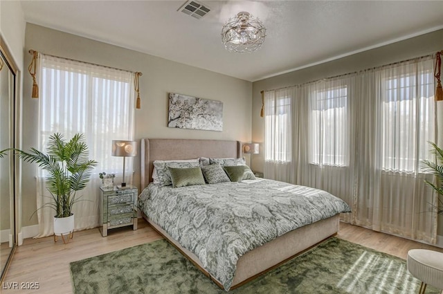 10550 Patrington Ct, Las Vegas, NV 89183 - bedroom with multiple windows, visible vents, and light wood-style floors