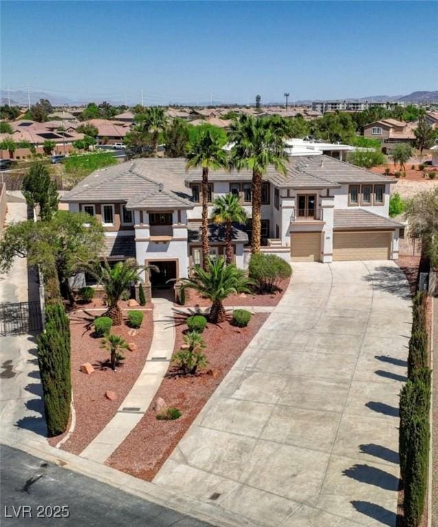10550 Patrington Ct, Las Vegas, NV 89183 - prairie-style home with concrete driveway, an attached garage, a residential view, and stucco siding