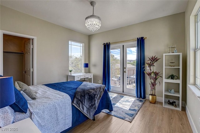 10550 Patrington Ct, Las Vegas, NV 89183 - bedroom featuring french doors, baseboards, a chandelier, wood finished floors, and access to outside