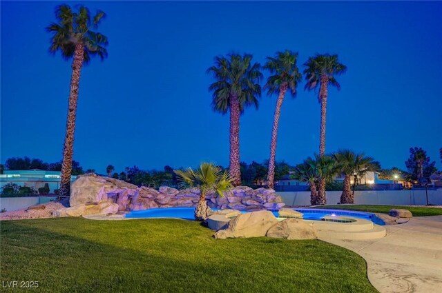 10550 Patrington Ct, Las Vegas, NV 89183 - pool at twilight featuring fence and a yard