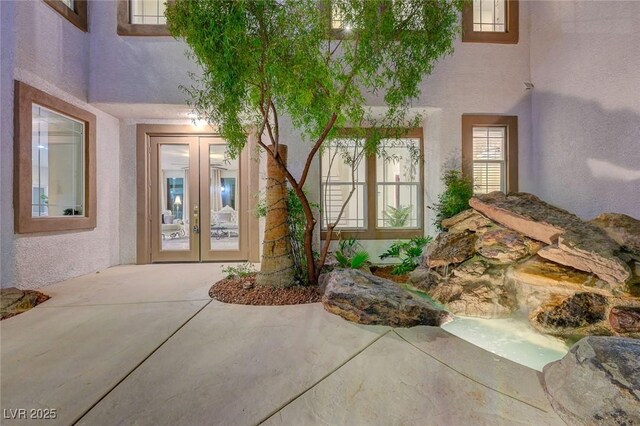 10550 Patrington Ct, Las Vegas, NV 89183 - view of exterior entry with a patio area, french doors, and stucco siding