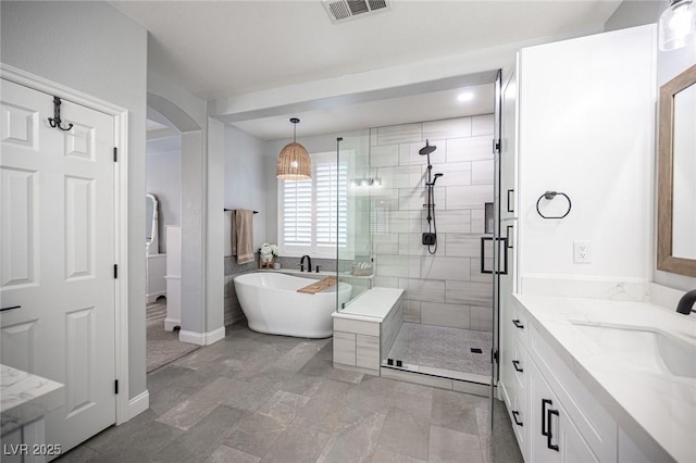 5815 Pristine Falls Ave, Las Vegas, NV 89131 - bathroom featuring vanity, a shower stall, a freestanding bath, and baseboards