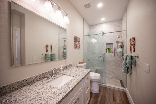 5815 Pristine Falls Ave, Las Vegas, NV 89131 - bathroom featuring toilet, vanity, a marble finish shower, wood finished floors, and recessed lighting