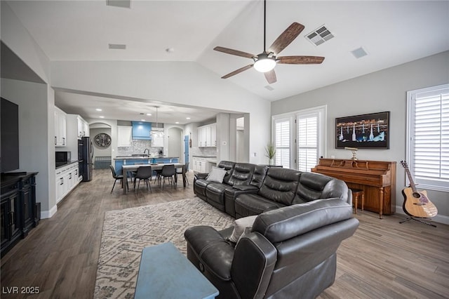 5815 Pristine Falls Ave, Las Vegas, NV 89131 - living area with ceiling fan, vaulted ceiling, wood finished floors, plenty of natural light, and baseboards