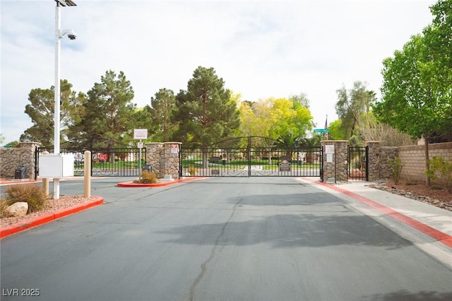 5815 Pristine Falls Ave, Las Vegas, NV 89131 - view of asphalt street featuring a gate, sidewalks, a gated entry, and curbs